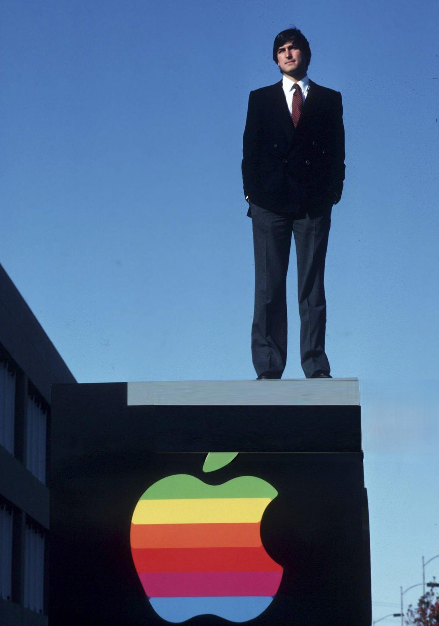 #18 Steve Jobs standing outside of Apple Computer Co., 1982.