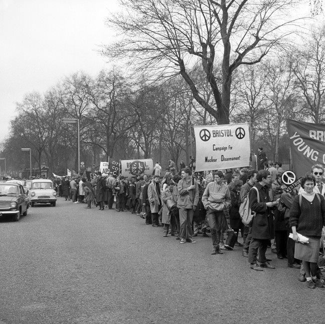 #27 A long column of ban the bomb marchers arrive at Hyde Park, London. The march had started from the Atomic Weapons Research Establishment at Aldermaston, 1963.