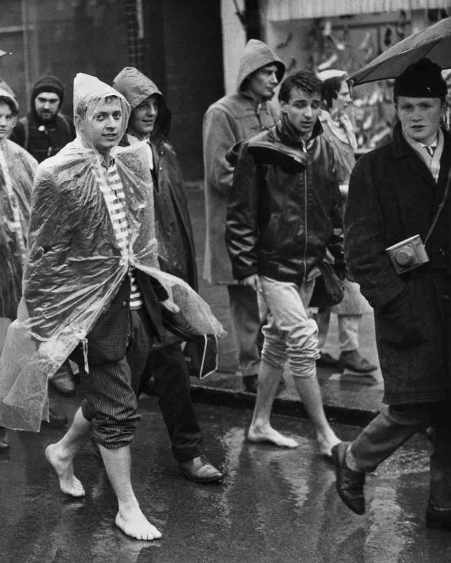 #7 A couple of barefooted youths with trousers rolled up trudge through Cheswick, west London, in the rain as the Aldermaston column of “Ban-the-bomb” marchers set off on the last weary lap of their long trek to Trafalgar Square, 1961.