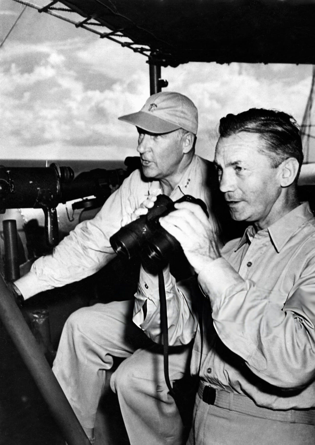 #13 Secretary of the U.S. Navy, James Forrestal (right), and Vice Admiral W.H.P. Blandy (left), commander of the joint Army-Navy Task Force 1, watch the atom bomb explode over Bikini Lagoon, 1946.