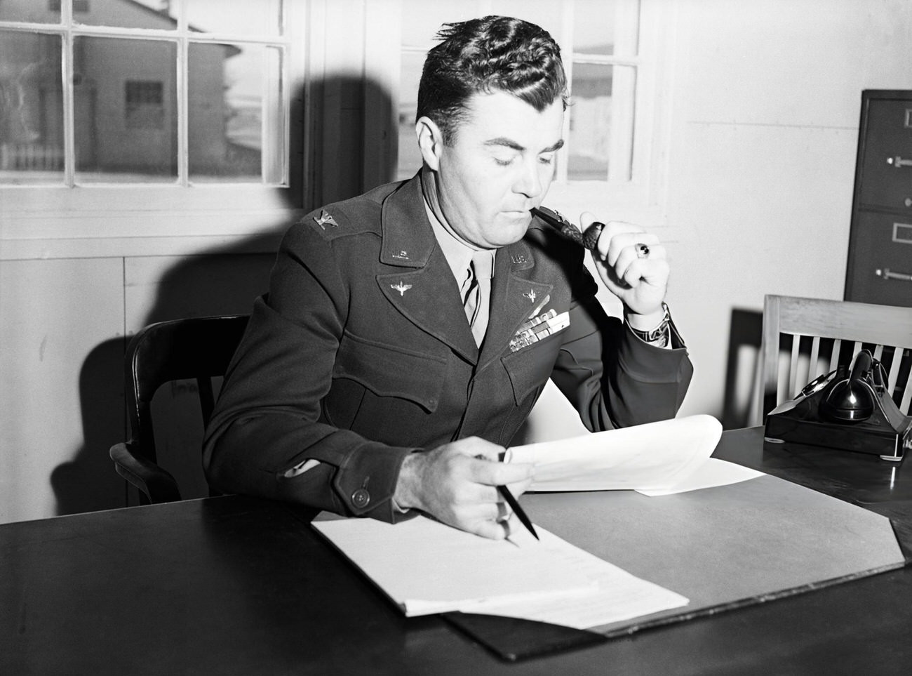 #18 Col. Paul W. Tibbets of Orlando, Fla., is shown in his office at Roswell Field where preliminary preparations are being made for the gigantic atomic bomb test scheduled for Bikini Atoll this summer, 1946.