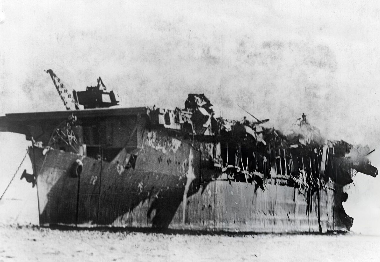#7 The remains of the light carrier the USS Independence, burning but still afloat, following America’s atomic bomb test in Bikini Lagoon, 1946.