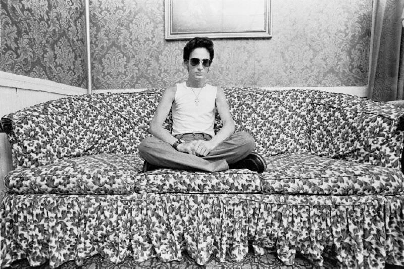 #6 A man sitting on a couch, 1977.