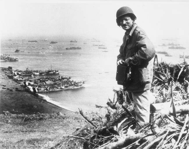 #25 Joe Rosenthal, Associated Press photographer, is shown with his camera equipment looking over Iwo Jima. 1945