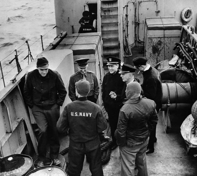 #26 A group of press correspondents chat on board a USS Landing Craft Infantry enroute to amphibious maneuvers somewhere off the coast of England. 1944
