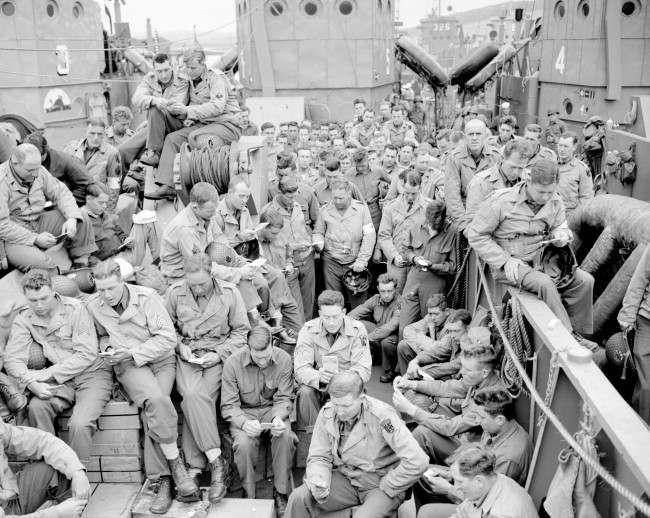 #14 U.S. serviceman attend a Protestant service aboard a landing craft, 1944.
