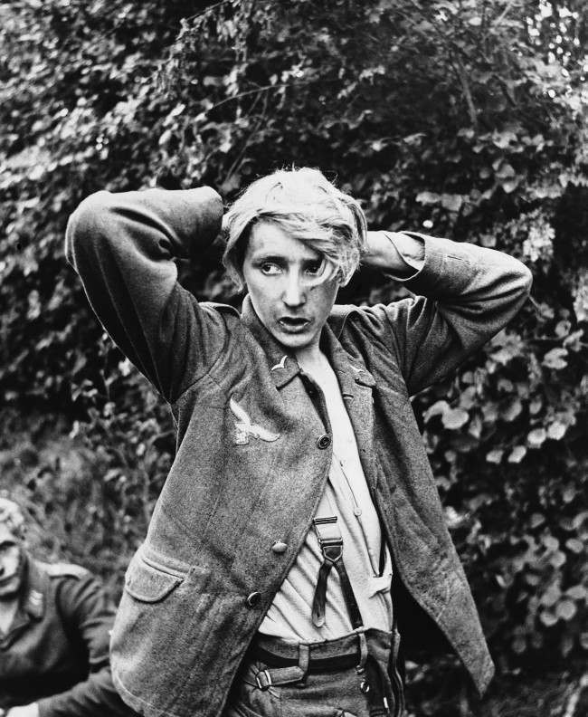 #18 A young German soldier captured by Allied forces at St. George D’’elle in Normandy looks furtively around, 1944.