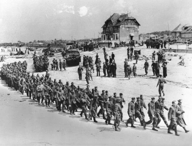 #23 German prisoners of war, captured during the Allied Normandy invasion, are marched to the ships, 1944.