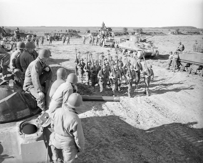 #3 Tank maintenance men practice on a firing range in England, 1944.