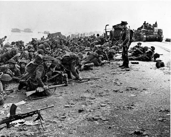 #36 After landing at the shore, these British troops wait for the signal to move forward, 1944.