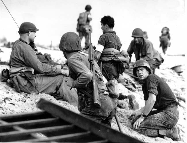 #39 A first wave beach battalion Ducks lays low under the fire of Nazi guns on the beach of southern France on D-Day, 1944.