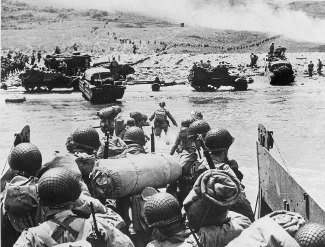 #43 American soldiers and supplies arrive on the shore of the French coast of German-occupied Normandy, 1944.