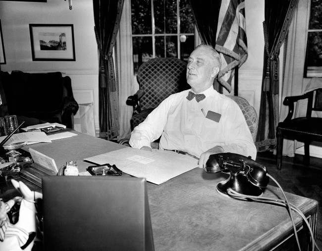 #50 U.S. President Franklin D. Roosevelt wears an expression of confidence and determination as he receives visitors in his White House office, 1944.