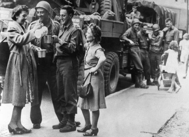 #6 British women pour tea for American soldiers heading for the south coast of England, 1944.