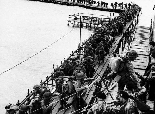 #8 British reinforcement troops from the Royal Pioneers Corps and Royal Engineers embark LCI at an English port, 1944.