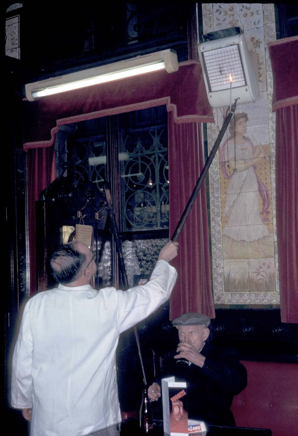 #10 Man adjusting gas heater at Bruxelles Bar 1964