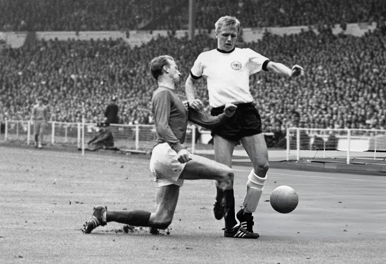 England’s Jackie Charlton tackling West Germany’s Held, during the World Cup Final, 1966.