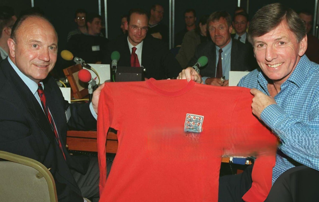 England’s Martin Peters and George Cohen are reunited with Roger Hunt’s red England No.21 International jersey, 1966.