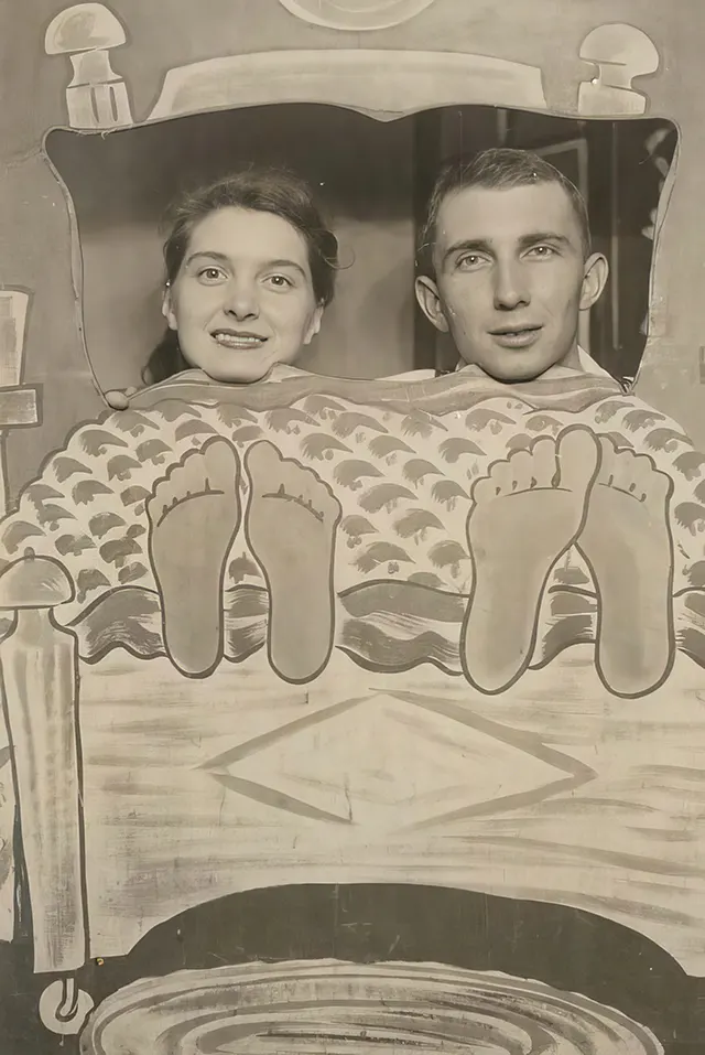 #1 A couple poses with oversized feet in an arcade photo.