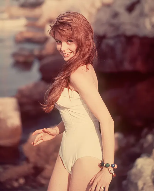 #10 A flirtatious Brigitte Bardot in a white swimsuit, 1950s.