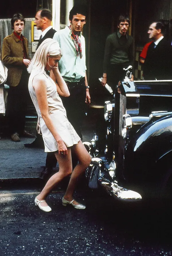 #17 A beautiful girl admiring her reflection in a Rolls Royce while men around her get mesmerized, London, 1968.