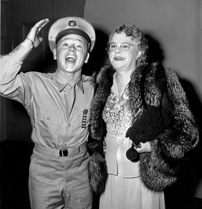 #13 Pvt. Mickey Rooney attends a Hollywood movie premiere with his mother, Nell Pankey, on Aug. 17, 1944. The actor is back in Hollywood after completing three months of basic training at Fort Riley, Kansas.