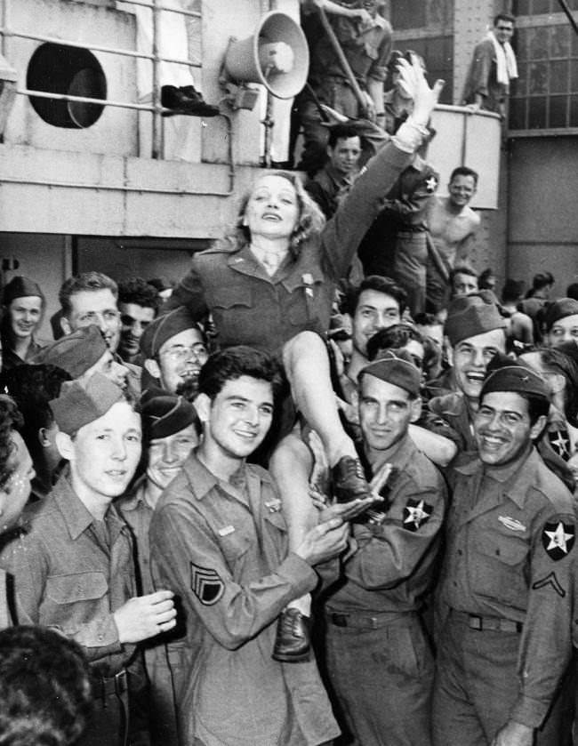#23 Movie actress Marlene Dietrich greets veterans on the Monticello after the ship docked in New York City on July 20, 1945 in World War II.