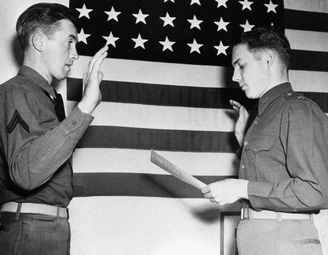 #27 Lieut. E.L. Reid, personnel officer of the west coast training center at Moffett Field, California, right, swears in Jimmy Stewart, former movie star, as a second lieutenant in the Air Corps on Jan. 1, 1941. Stewart, who was one of HollywoodÂs most popular actors before he was inducted into the Army in 1941, was a corporal.