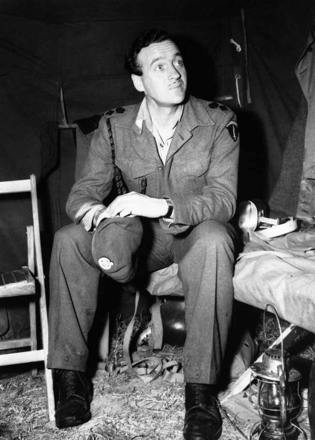 #32 Lieutenant Colonel David Niven, British film star, now with SHAEF, seen in his tent somewhere in Normandy, France on July 5, 1944.