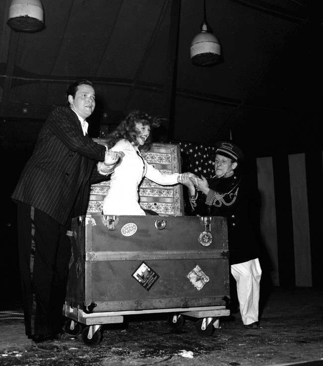 #36 Soldiers cheered when Rita Hayworth, film star, was found again in a trunk, after Orson Welles, director-magician, had tied her in ropes and caused her to vanish on August 9, 1943 in Hollywood.