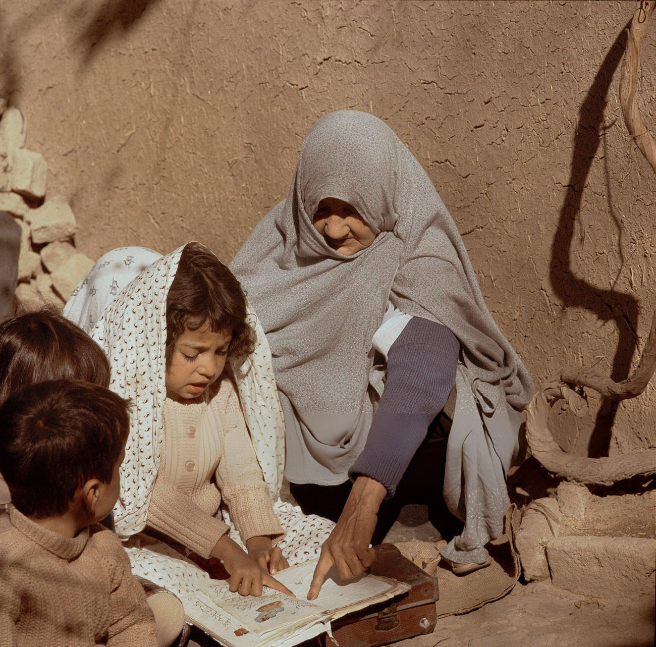 #9 An elderly teacher instructs a girl how to read in a small village school in Iran, 1960s.