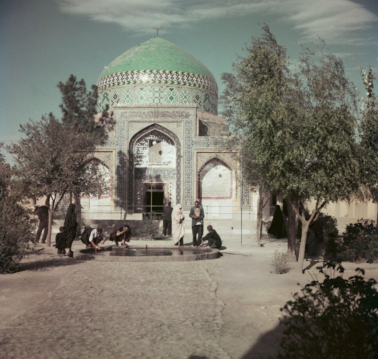 #15 Visitors washing their hands and faces in a pool in front of a shrine near Mashhad, the capital of Razavi Khorasan Province in Iran, circa 1960.