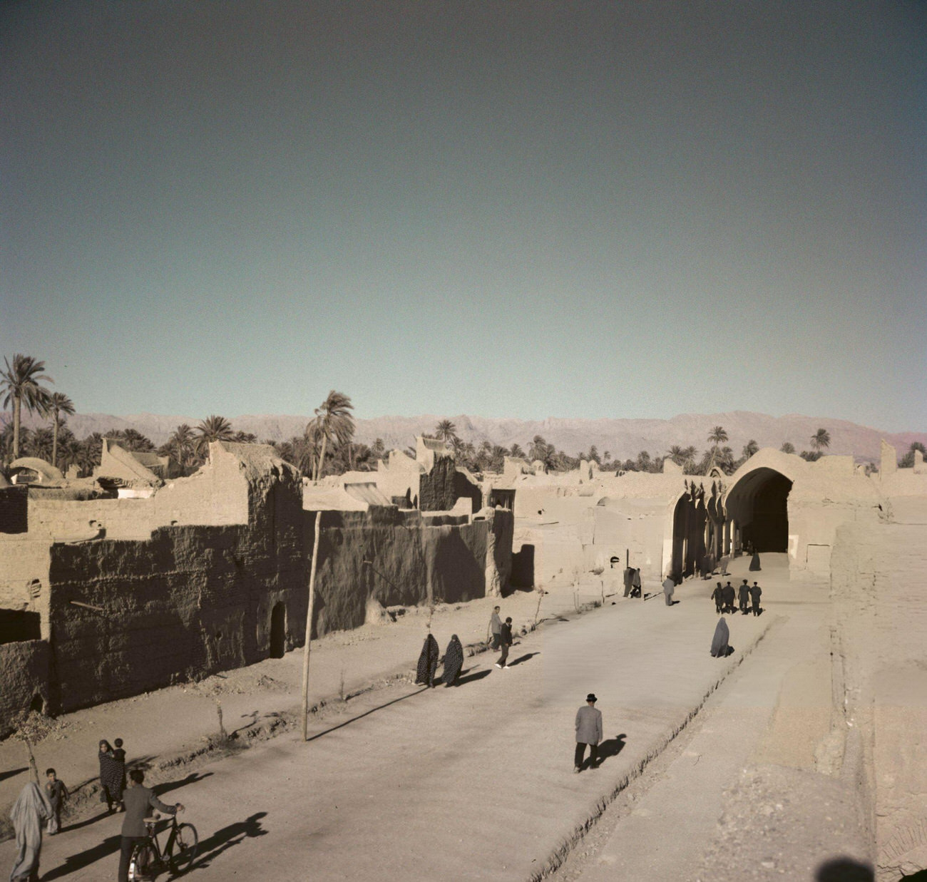 #19 Pedestrians walking along a road in the oasis city of Tabas, formerly known as Golshan, in the province of South Khorasan in central Iran, circa 1960.