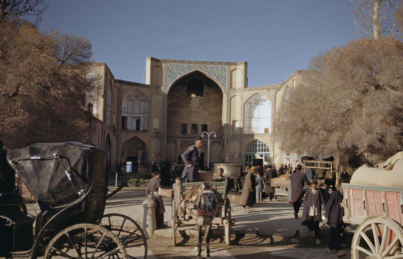 #21 Traders’ carts unloaded outside the entrance to the bazaar in Isfahan, in the Isfahan Province of Iran, circa 1960.