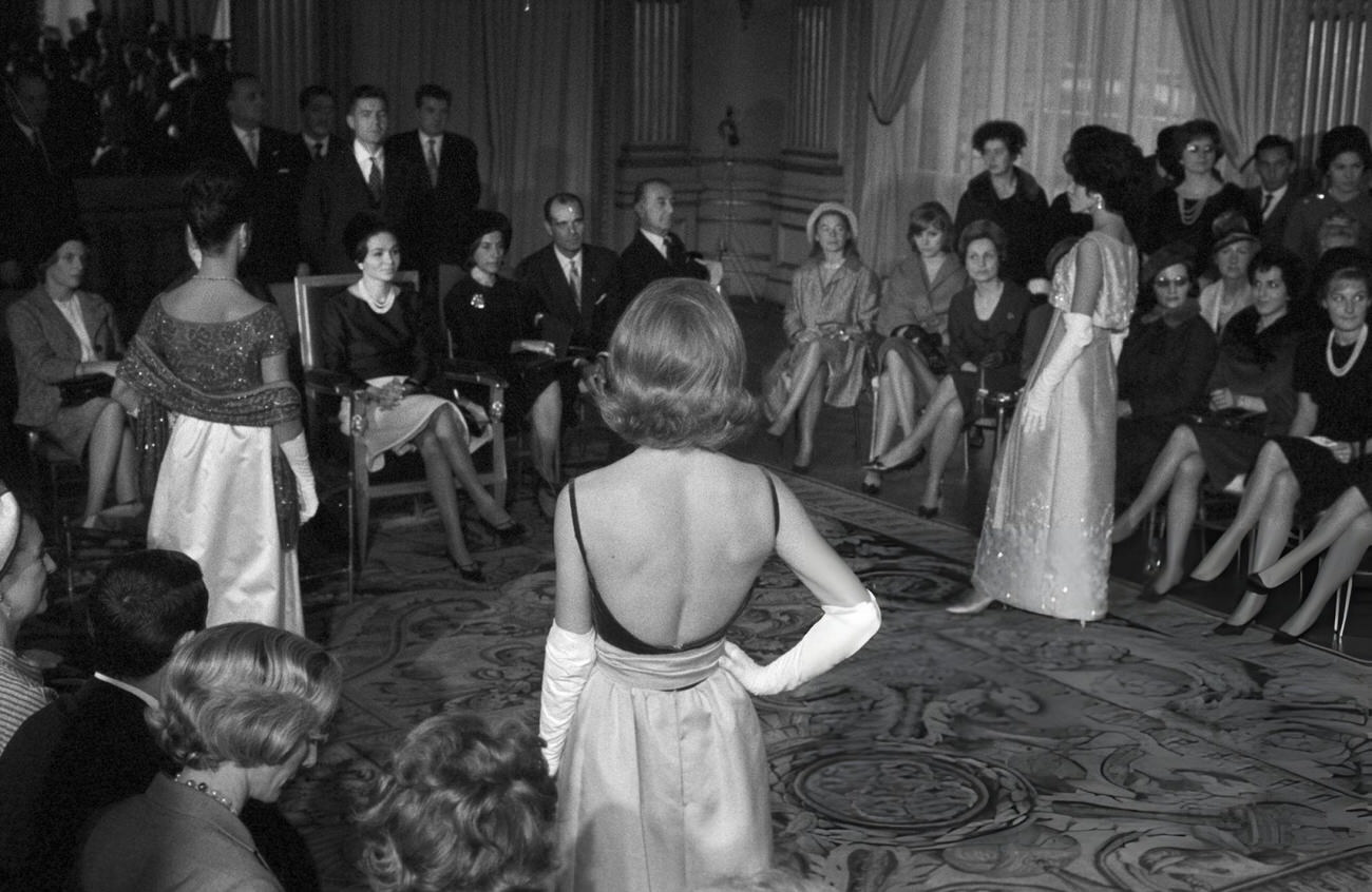 #55 Farah Diba, Empress of Iran, attends a fashion show organized in her honor during the official visit of Shah Mohammad Reza Pahlavi to France, 1961.