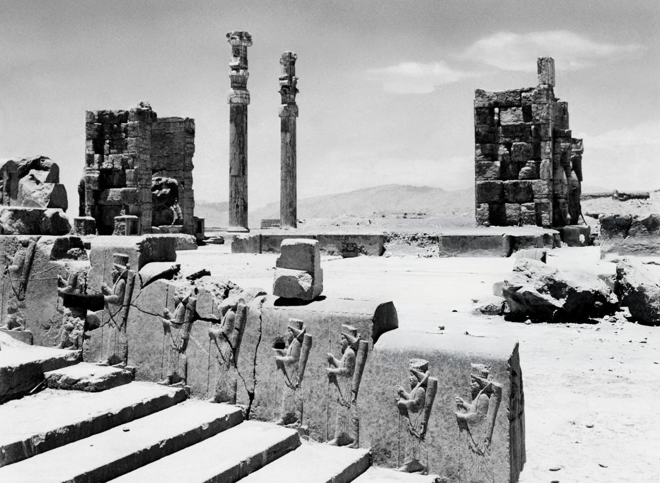 #57 The stairway of King Darius depicted with his servants at the ruins of Persepolis, 1963.