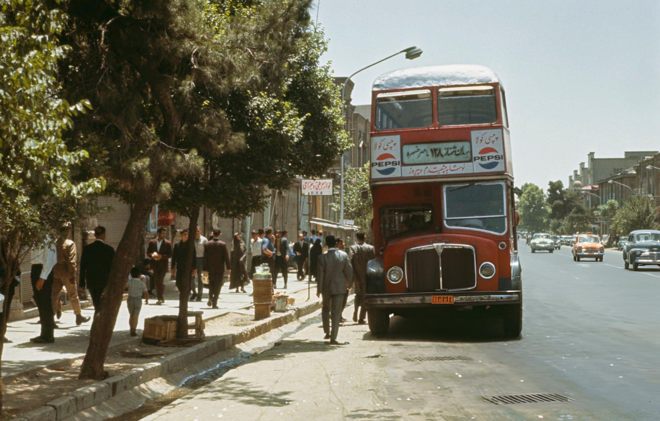 #62 Pedestrians walking past an AEC Regent V double-decker bus at a bus stop on Ferdausi Street in Tehran, the capital of Iran, 1967.