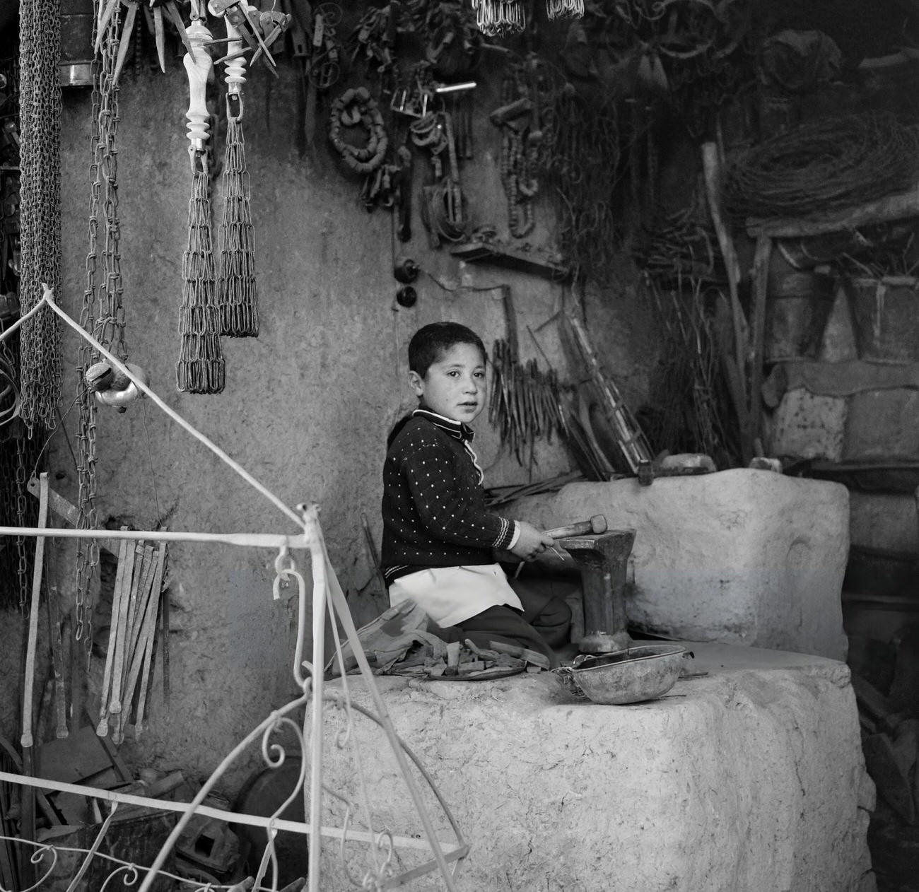 #78 A child plays in a workshop in Tehran, Iran, 1968.