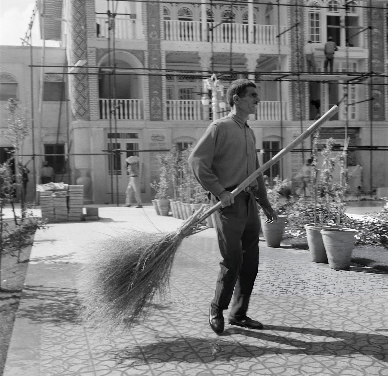 #80 An Iranian man sweeping a street in a city of Iran, 1968.