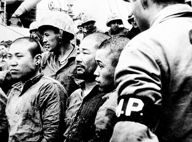 #31 Three Japanese prisoners of war are shown aboard a U.S. Navy vessel in Japan, 1945.