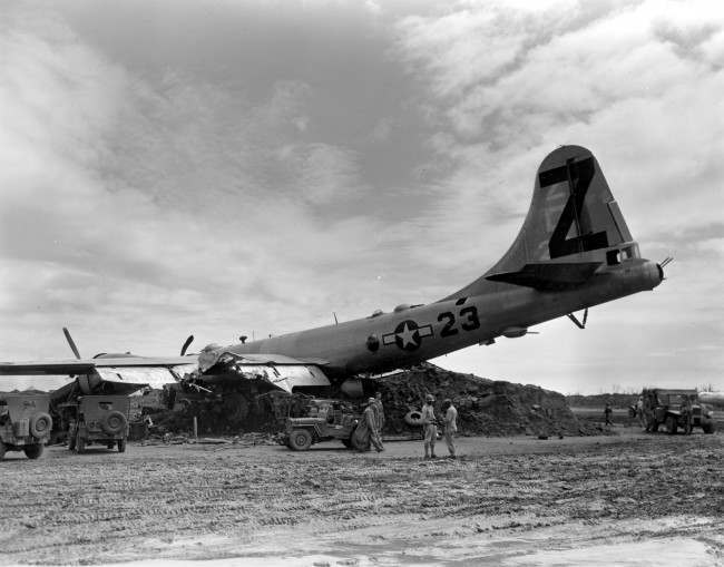 #40 A B-29 Superfortress rests on a dirt mound after it crash landed with two engines working at Iwo Jima, Japan, during World War II, 1945.