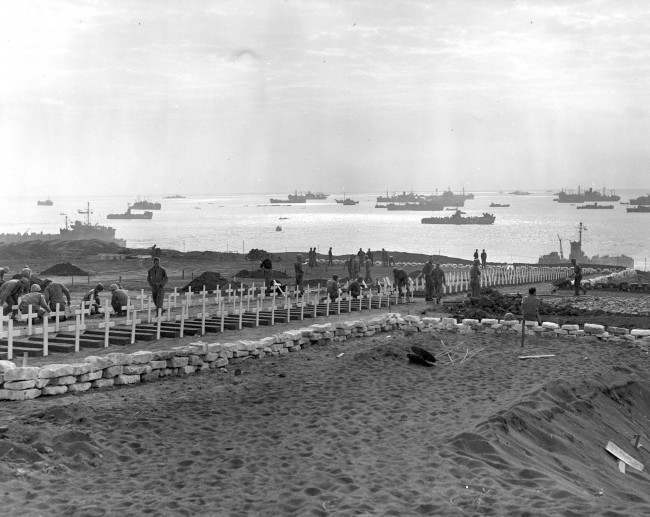 #42 This is a photo of U.S. Marines preparing graves in the cemetery of the third and Fourth Marine Divisions for their buddies who died in taking the island of Iwo Jima, Japan, during World War II, 1945.