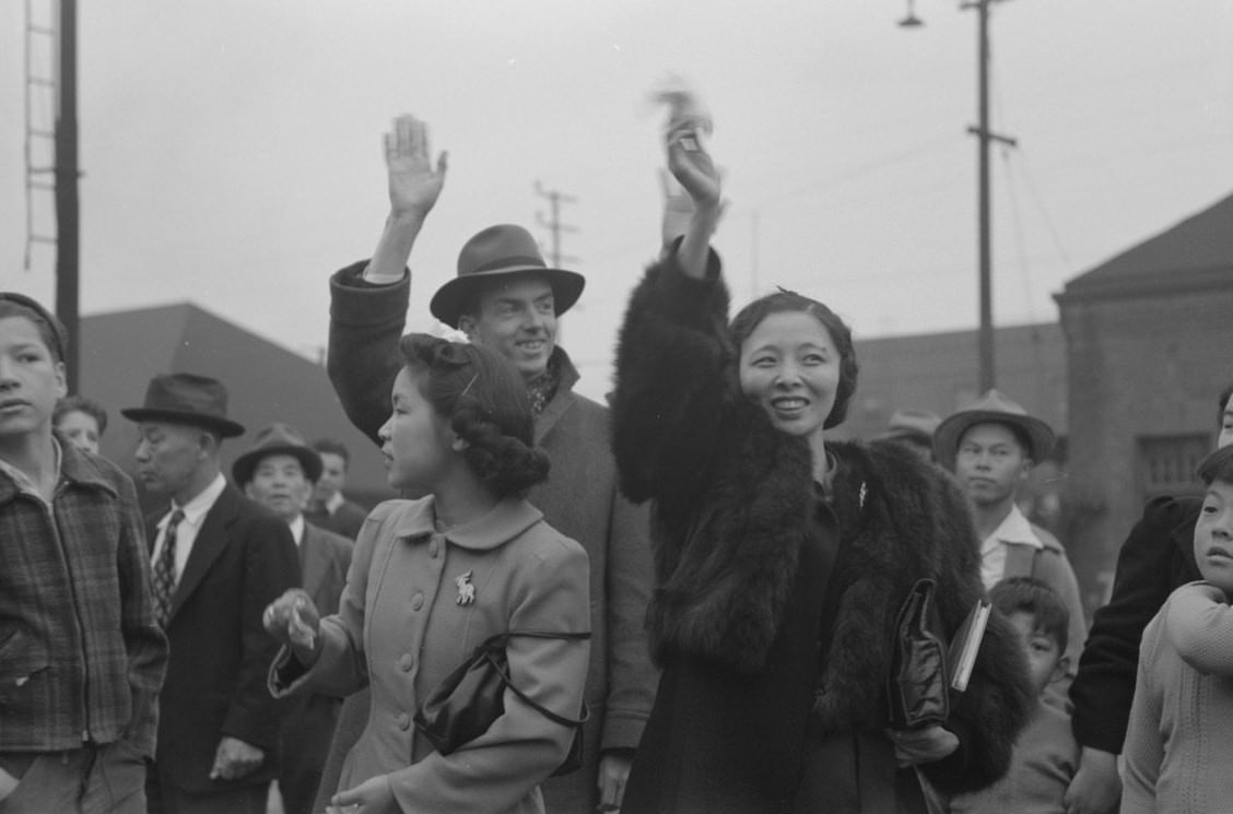 #11 Waving good-bye to friends and relatives who are leaving for Owens Valley, 1942.