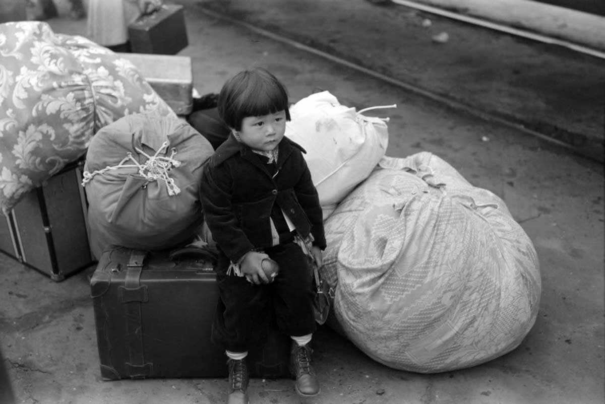 #9 Los Angeles, California. Japanese-American child being evacuated with his parents to Owens Valley, 1942.