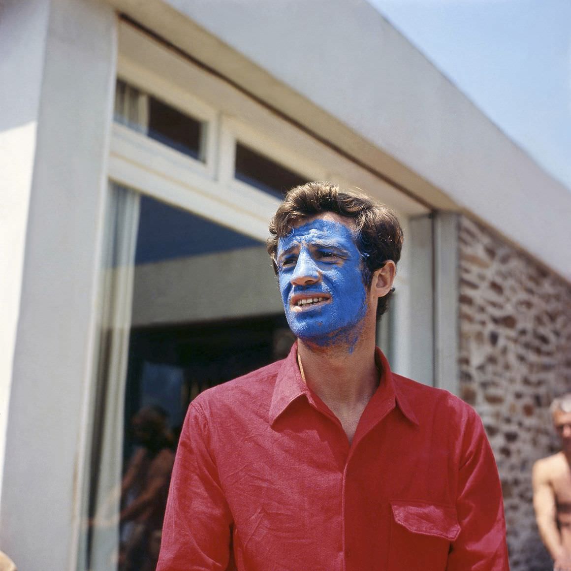 #13 Jean-Paul Belmondo in ‘Pierrot le fou’ directed by Jean-Luc Godard, 1965.