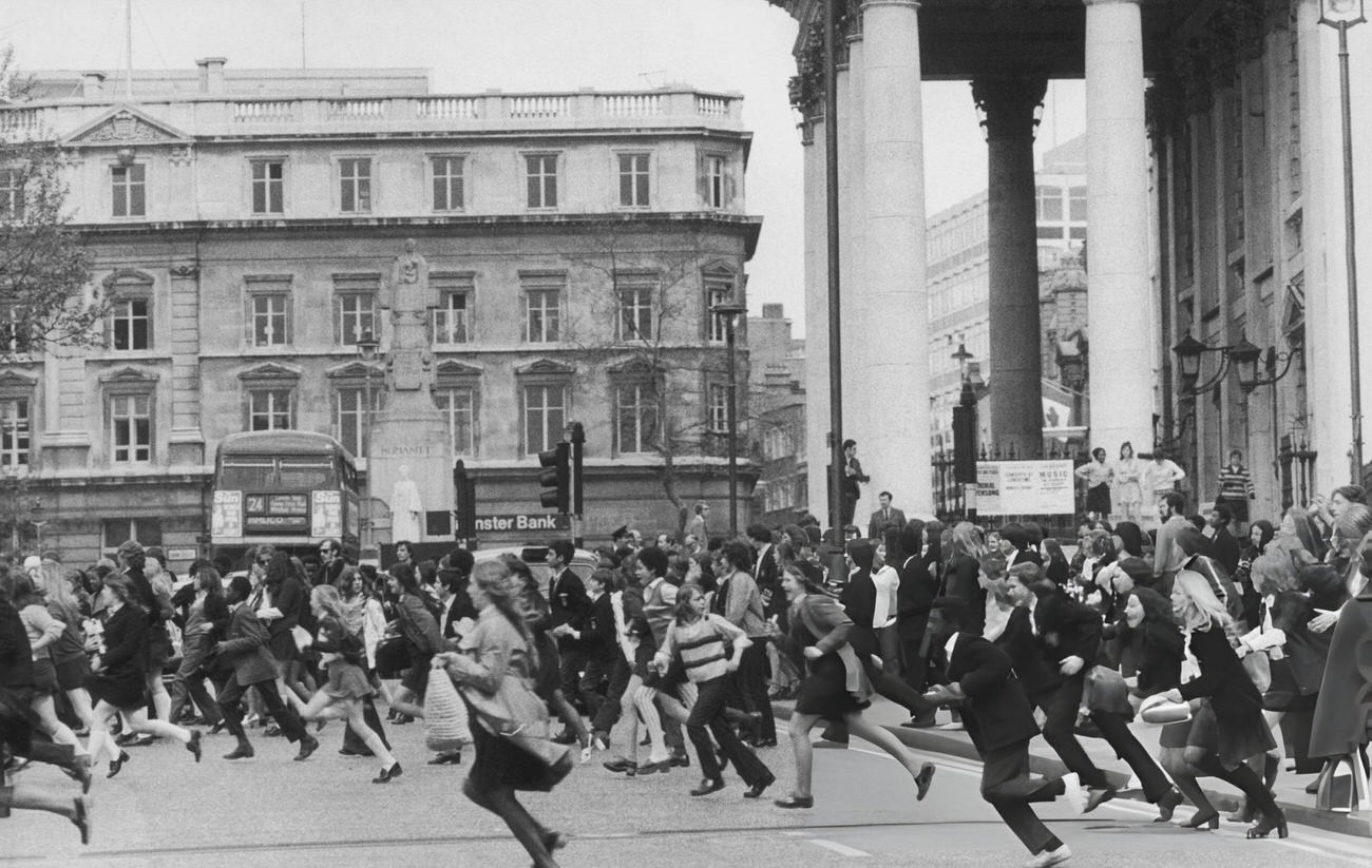 #13 Pupils running across a road during a school strike demonstration, Trafalgar Square, London, 1972.