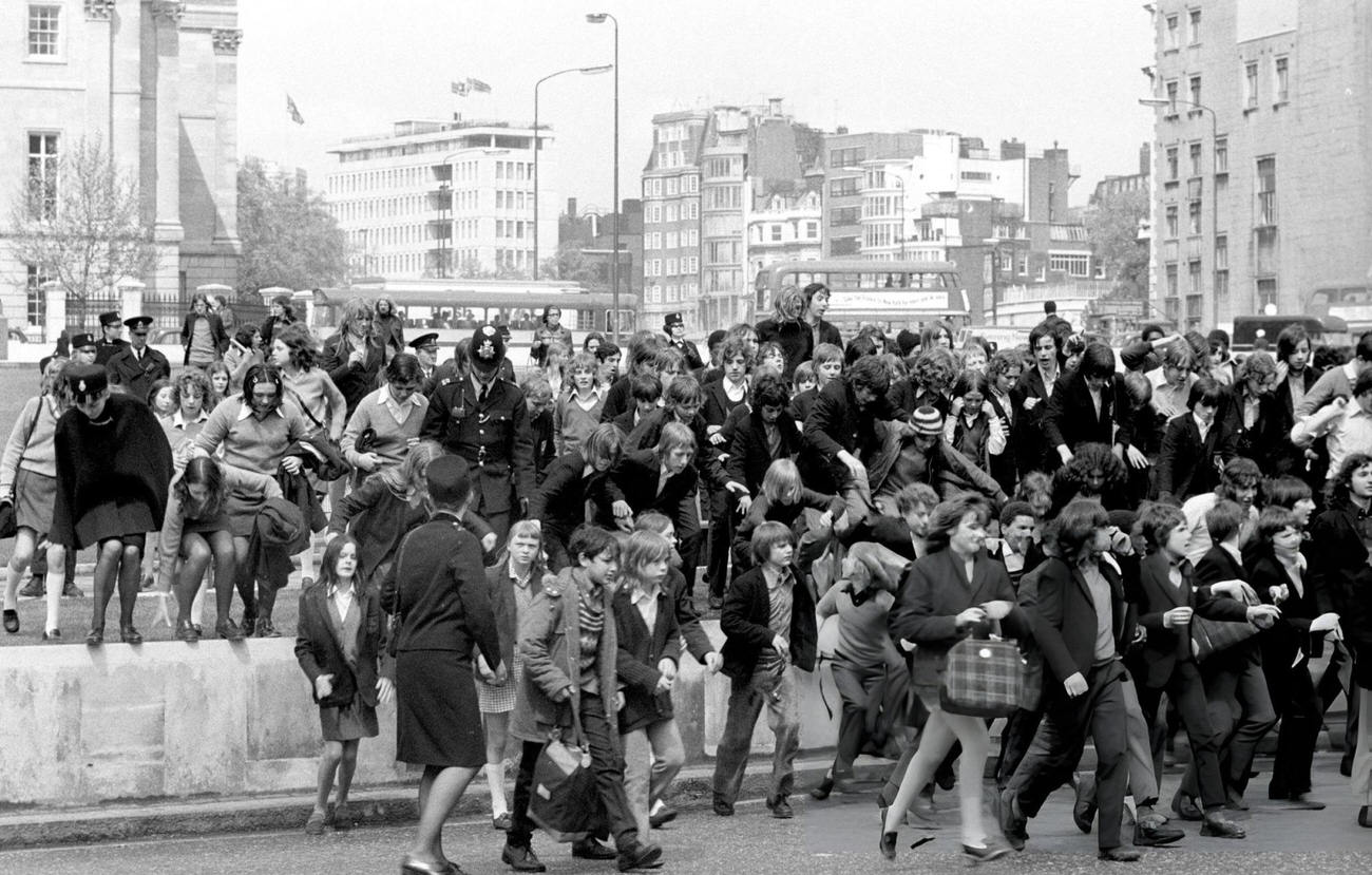 #24 Schoolchildren clamber over the verges in Hyde Park, where a ‘pupil power’ demonstration took place at Speakers’ Corner. They then marched to County Hall, 1972.