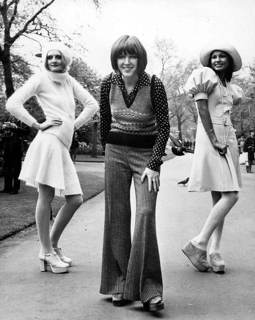 #21 Mary Quant – posing with two of her autumn collection outfits in May 1972