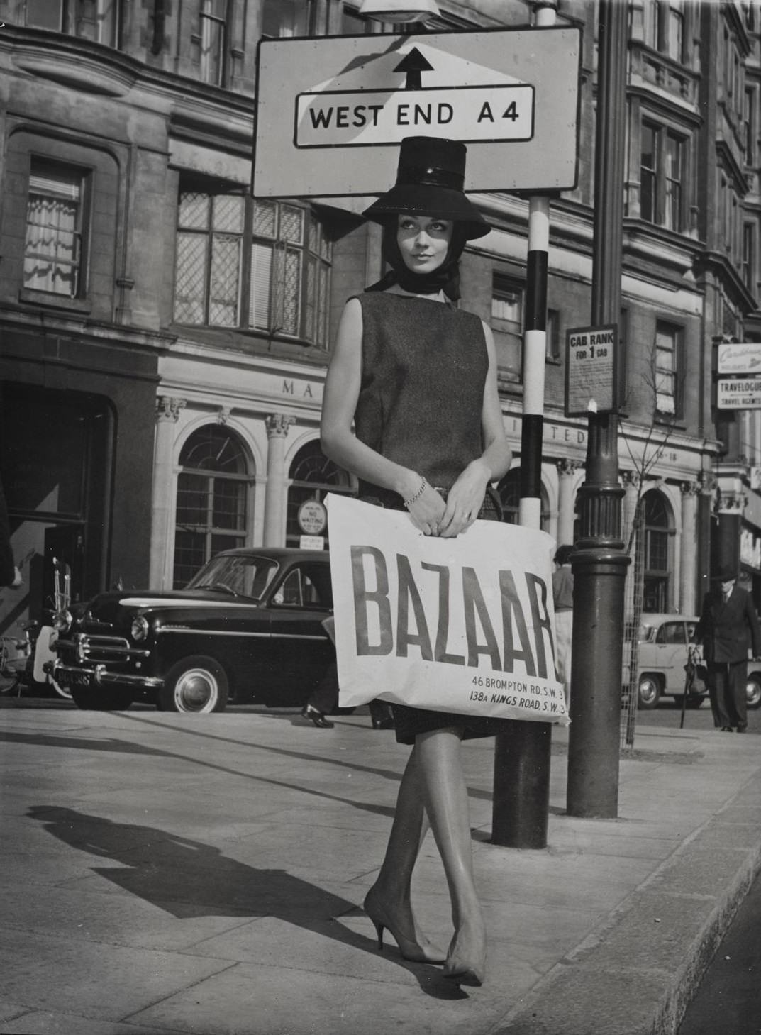 #6 Model holding a Bazaar bag outside Bazaar and the Markham Arms on the King’s Road c.1959