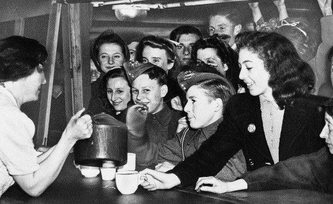 #28 Young Londoners, in a shelter against Hitler’s robot bombs, crowd the canteen for refreshments, deep under the city of London, July 25, 1944. When completed, the shelters will provide sleeping accommodations for 40,000 persons.